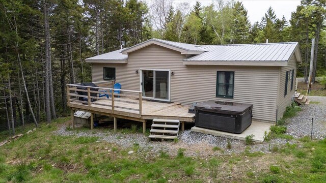 144 Woody Ln, Cushing, ME 04563 - rear view of house featuring a deck and metal roof