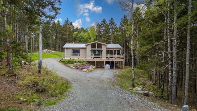 144 Woody Ln, Cushing, ME 04563 - view of front of house featuring dirt driveway, a forest view, and metal roof