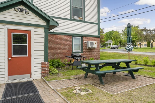 15 Mill Hl Unit 2B, Bethel, ME 04217 - property entrance with brick siding, a patio area, and a yard