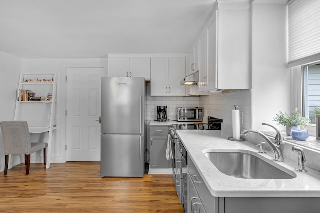 15 Mill Hl Unit 2B, Bethel, ME 04217 - kitchen featuring freestanding refrigerator, a sink, gray cabinetry, light stone counters, and light wood-style flooring