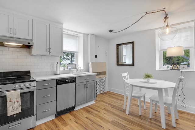 15 Mill Hl Unit 2B, Bethel, ME 04217 - kitchen featuring stainless steel appliances, gray cabinetry, under cabinet range hood, and healthy amount of natural light