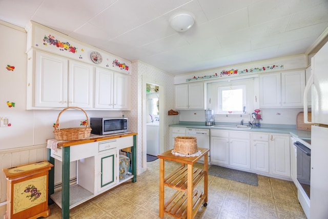 33 Neally St, South Berwick, ME 03908 - kitchen featuring stainless steel microwave, white cabinets, white dishwasher, light floors, and a wainscoted wall