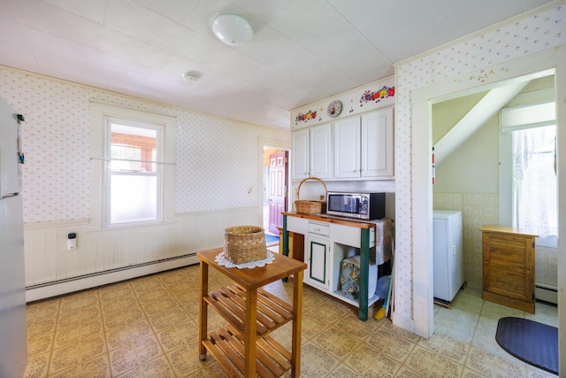 33 Neally St, South Berwick, ME 03908 - kitchen featuring stainless steel microwave, a baseboard heating unit, wainscoting, white cabinets, and washer / clothes dryer