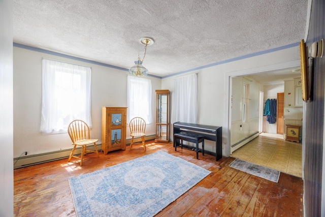 33 Neally St, South Berwick, ME 03908 - sitting room featuring crown molding, hardwood / wood-style floors, a baseboard heating unit, a chandelier, and a textured ceiling