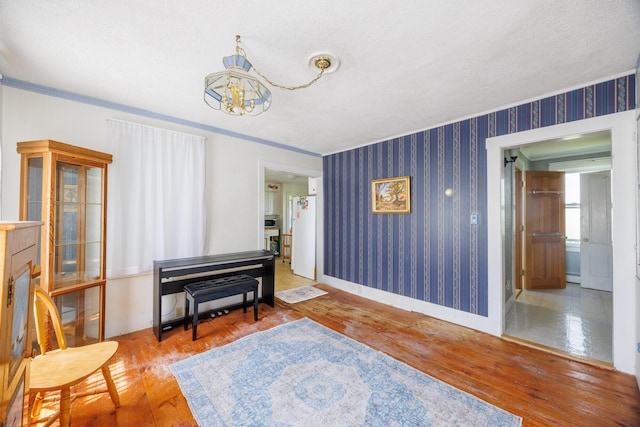 33 Neally St, South Berwick, ME 03908 - living area featuring hardwood / wood-style floors, a chandelier, wallpapered walls, baseboards, and crown molding