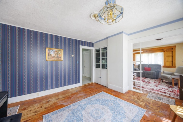 33 Neally St, South Berwick, ME 03908 - interior space with hardwood / wood-style flooring, a chandelier, a textured ceiling, and baseboards