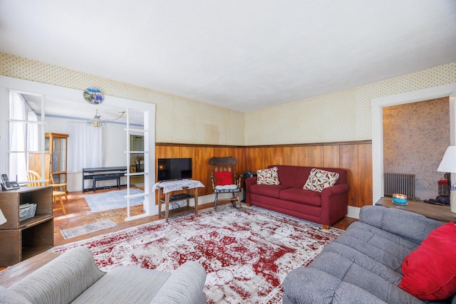 33 Neally St, South Berwick, ME 03908 - living area featuring wallpapered walls, wainscoting, radiator, wood finished floors, and a chandelier