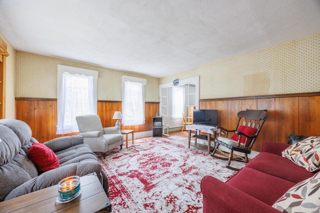 33 Neally St, South Berwick, ME 03908 - living area with wallpapered walls, wainscoting, wood walls, a textured ceiling, and wood finished floors