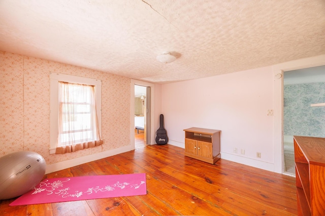 33 Neally St, South Berwick, ME 03908 - exercise room featuring hardwood / wood-style flooring, baseboards, wallpapered walls, and a textured ceiling