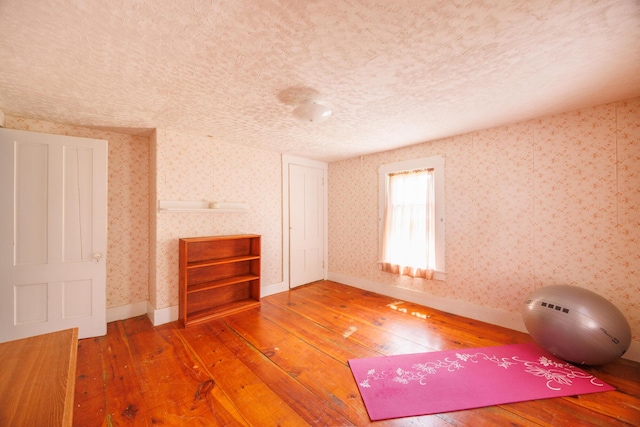33 Neally St, South Berwick, ME 03908 - workout area with hardwood / wood-style flooring, baseboards, a textured ceiling, and wallpapered walls