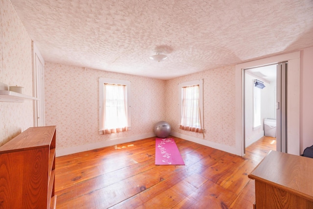 33 Neally St, South Berwick, ME 03908 - workout area with light wood finished floors, plenty of natural light, a textured ceiling, baseboards, and wallpapered walls