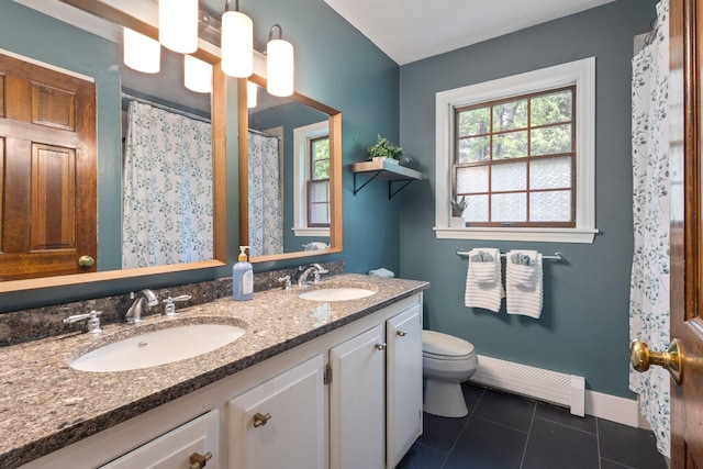 39 Solomon Dr, Gorham, ME 04038 - bathroom featuring baseboard heating, double vanity, toilet, tile patterned floors, and baseboards
