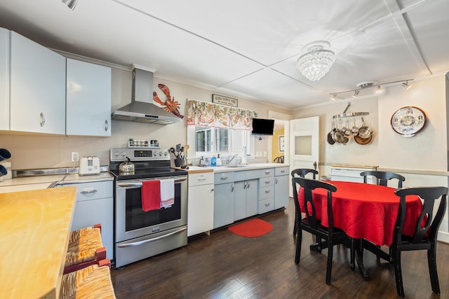 75 Ledgelawn Ave, Bar Harbor, ME 04609 - kitchen featuring stainless steel range with electric cooktop, wall chimney exhaust hood, dark wood-type flooring, a chandelier, and ornamental molding