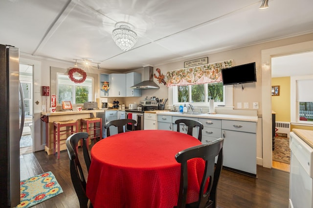 75 Ledgelawn Ave, Bar Harbor, ME 04609 - dining area featuring dark wood finished floors, radiator heating unit, a chandelier, and crown molding