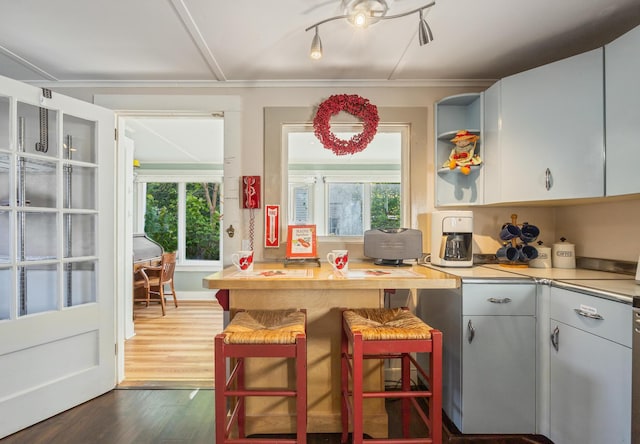 75 Ledgelawn Ave, Bar Harbor, ME 04609 - kitchen with healthy amount of natural light, dark wood-type flooring, light countertops, and open shelves