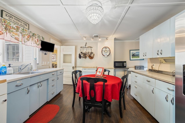 75 Ledgelawn Ave, Bar Harbor, ME 04609 - kitchen featuring black microwave, dark wood-style floors, light countertops, a chandelier, and ornamental molding