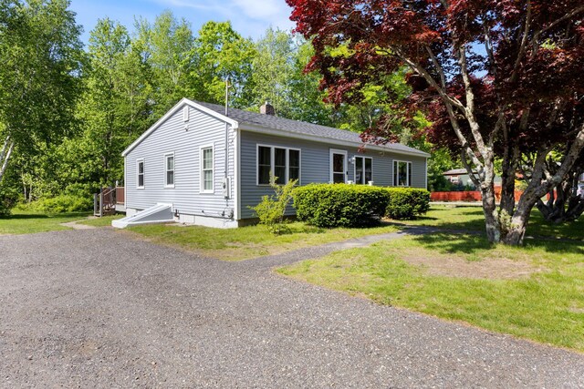 165 Temple Ave Unit 1, Old Orchard Beach, ME 04064 - view of front of home with a chimney and a front lawn