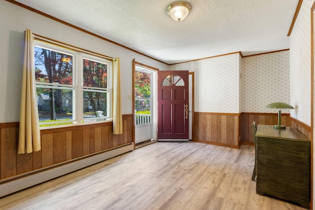 165 Temple Ave Unit 1, Old Orchard Beach, ME 04064 - entryway with a baseboard radiator, a wainscoted wall, ornamental molding, light wood finished floors, and a textured ceiling