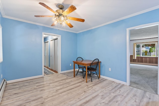 165 Temple Ave Unit 1, Old Orchard Beach, ME 04064 - unfurnished dining area featuring wood finished floors, a ceiling fan, baseboards, crown molding, and baseboard heating