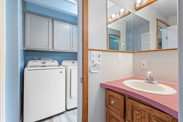 165 Temple Ave Unit 1, Old Orchard Beach, ME 04064 - bathroom with separate washer and dryer, vanity, and wood finished floors