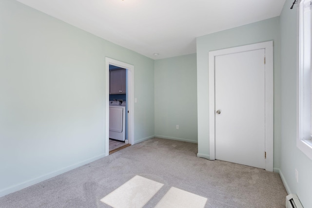 165 Temple Ave Unit 1, Old Orchard Beach, ME 04064 - unfurnished bedroom with a baseboard heating unit, light carpet, and baseboards
