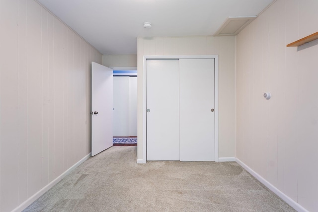 165 Temple Ave Unit 1, Old Orchard Beach, ME 04064 - unfurnished bedroom featuring light carpet, a closet, wooden walls, and baseboards