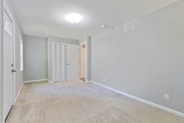 165 Temple Ave Unit 1, Old Orchard Beach, ME 04064 - unfurnished bedroom with light colored carpet, a closet, and baseboards