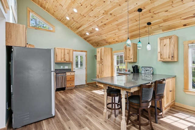 31 Middle Rd, Acton, ME 04001 - kitchen with freestanding refrigerator, wooden ceiling, light brown cabinetry, a peninsula, and a kitchen bar
