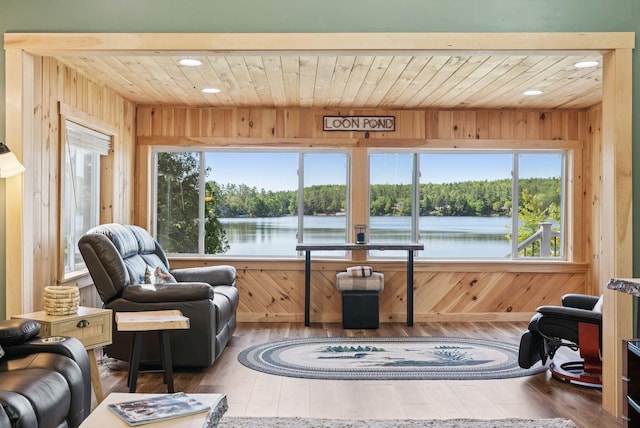 31 Middle Rd, Acton, ME 04001 - living area featuring wood ceiling, plenty of natural light, wood-type flooring, a water view, and wooden walls