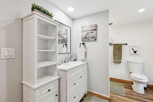 31 Middle Rd, Acton, ME 04001 - bathroom with vanity, wood finished floors, toilet, baseboards, and recessed lighting