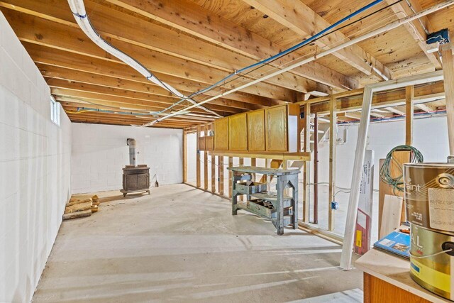16 Van Buren Dr, Newfield, ME 04095 - unfinished basement featuring a wood stove and concrete block wall