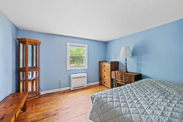 16 Van Buren Dr, Newfield, ME 04095 - bedroom with heating unit, wood-type flooring, and baseboards
