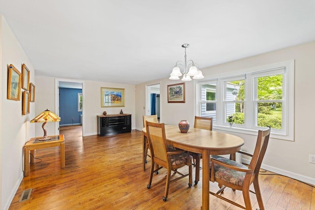 16 Van Buren Dr, Newfield, ME 04095 - dining area featuring light wood-style floors, a chandelier, and baseboards