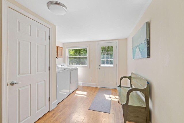 16 Van Buren Dr, Newfield, ME 04095 - laundry area featuring independent washer and dryer, light wood finished floors, baseboards, and cabinet space