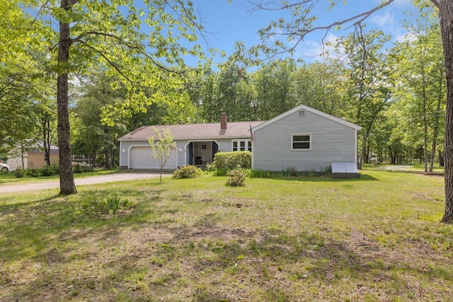 16 Van Buren Dr, Newfield, ME 04095 - view of front of house with a garage, a chimney, a front lawn, and dirt driveway