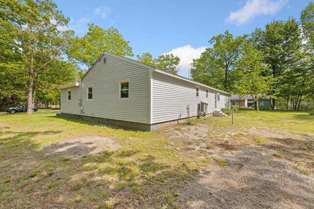 16 Van Buren Dr, Newfield, ME 04095 - view of home's exterior featuring central AC unit and a lawn