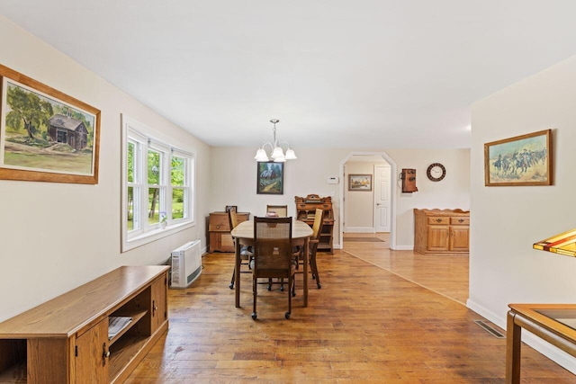 16 Van Buren Dr, Newfield, ME 04095 - dining area with light wood-type flooring, arched walkways, a chandelier, and baseboards
