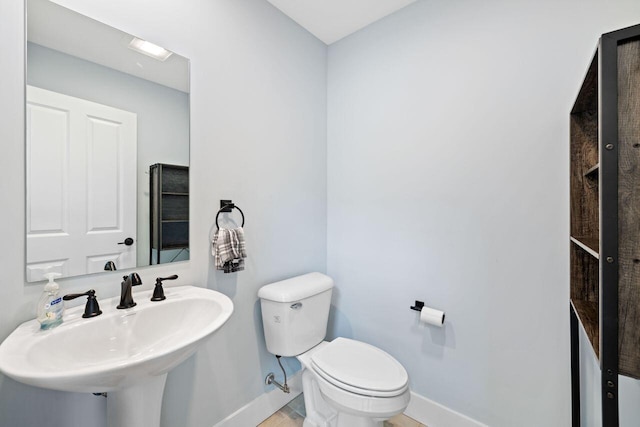 12 Haleys Ct Unit 21, Wells, ME 04090 - half bathroom featuring baseboards, toilet, and a sink