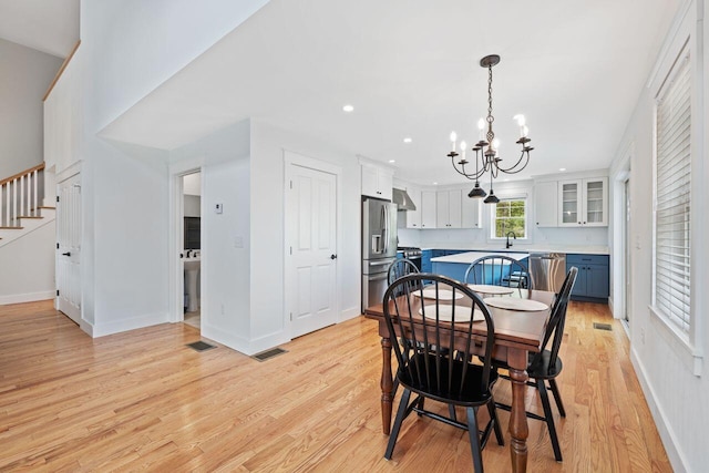 12 Haleys Ct Unit 21, Wells, ME 04090 - dining space featuring a chandelier, stairway, light wood-style floors, recessed lighting, and baseboards