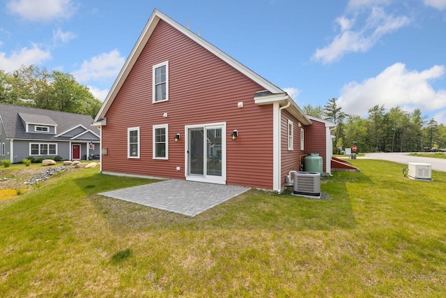 12 Haleys Ct Unit 21, Wells, ME 04090 - rear view of house featuring a patio, a lawn, and cooling unit