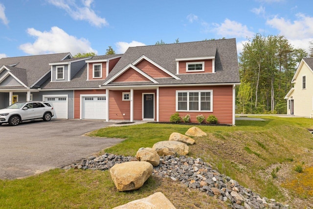 12 Haleys Ct Unit 21, Wells, ME 04090 - view of front of property featuring a garage, driveway, roof with shingles, and a front lawn