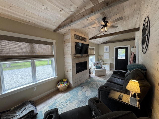 588 Mason Bay Rd, Jonesport, ME 04649 - living area with wood finished floors, wooden ceiling, baseboards, a large fireplace, and a ceiling fan