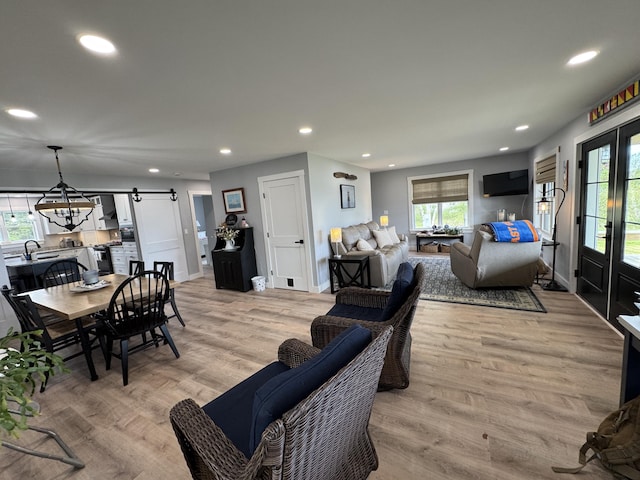 588 Mason Bay Rd, Jonesport, ME 04649 - living room featuring recessed lighting, light wood-style flooring, baseboards, and a chandelier