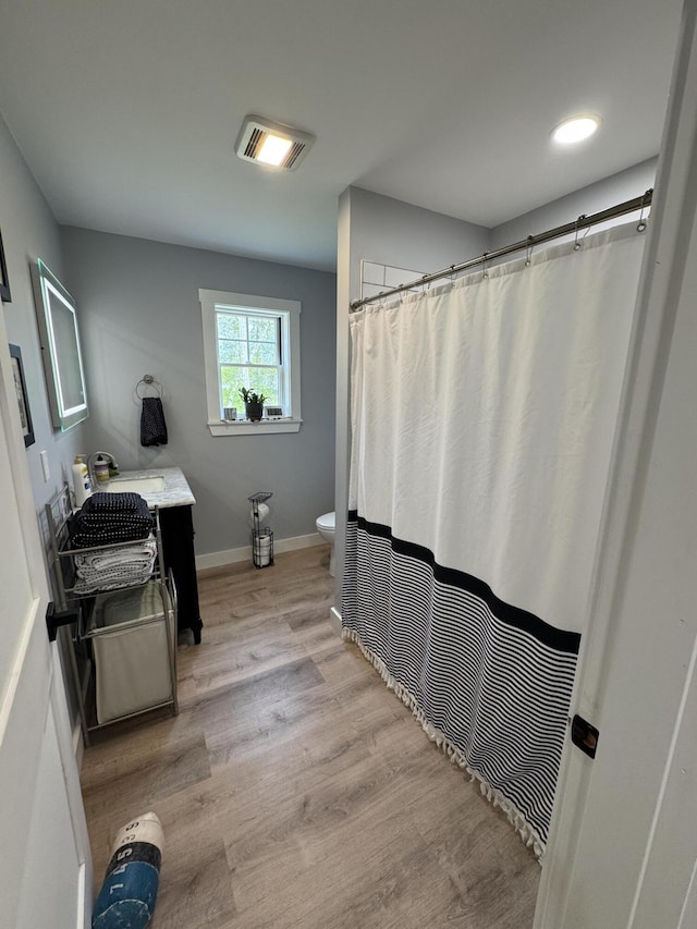 588 Mason Bay Rd, Jonesport, ME 04649 - full bathroom with toilet, wood finished floors, vanity, baseboards, and a shower with curtain