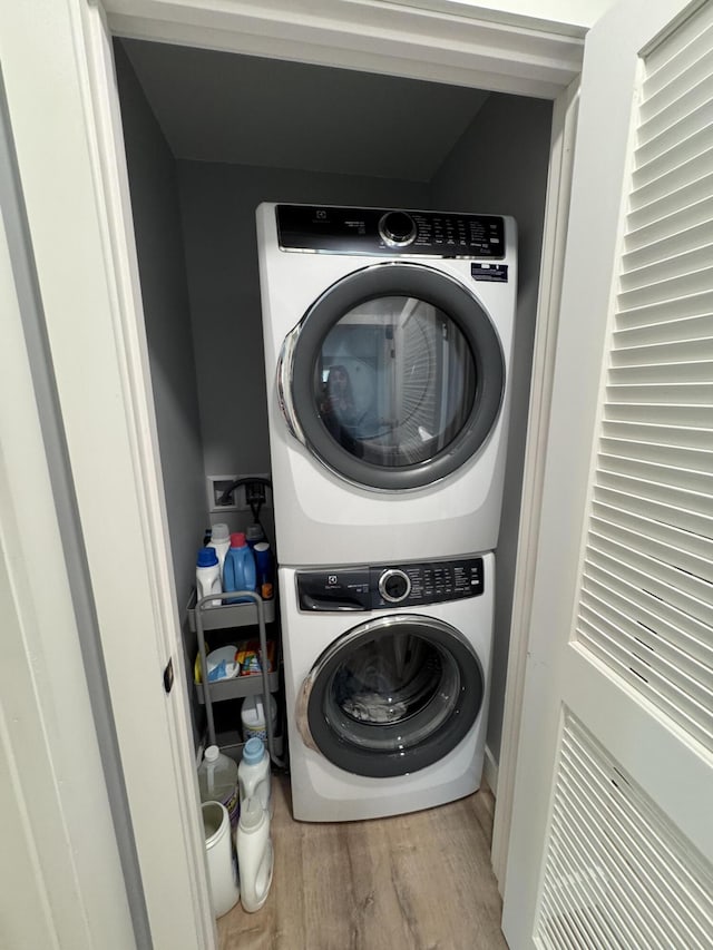 588 Mason Bay Rd, Jonesport, ME 04649 - washroom featuring stacked washer and clothes dryer and wood finished floors