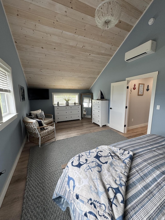 588 Mason Bay Rd, Jonesport, ME 04649 - bedroom with a wall unit AC, vaulted ceiling, wooden ceiling, wood finished floors, and baseboards