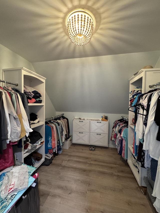 588 Mason Bay Rd, Jonesport, ME 04649 - spacious closet featuring lofted ceiling, a chandelier, and wood finished floors