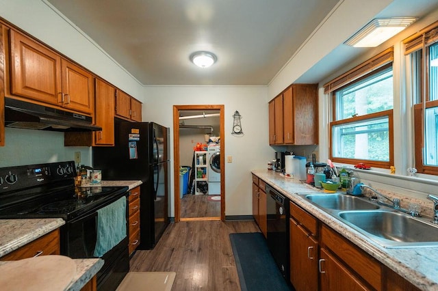56 Intrepid St, Brunswick, ME 04011 - kitchen featuring under cabinet range hood, black appliances, washer / clothes dryer, a sink, and dark wood finished floors