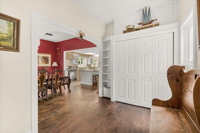 44 Bridge St, Bucksport, ME 04416 - sitting room with arched walkways and dark wood-style floors