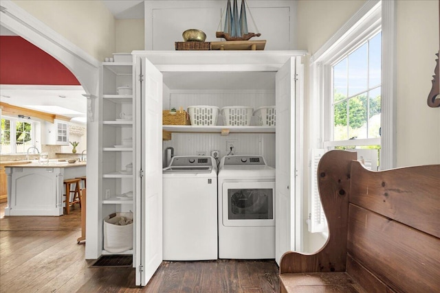 44 Bridge St, Bucksport, ME 04416 - laundry room with washer and dryer, dark wood-style floors, and arched walkways